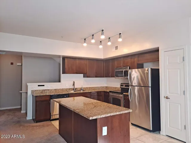 a kitchen with a sink a refrigerator and a stove
