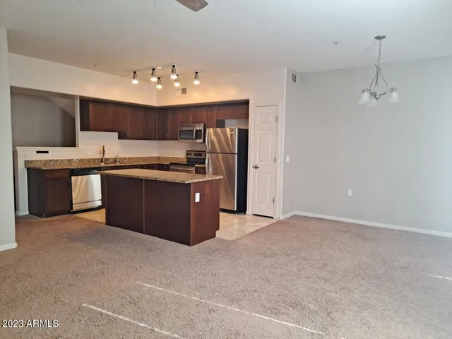 a kitchen with stainless steel appliances granite countertop a sink and cabinets