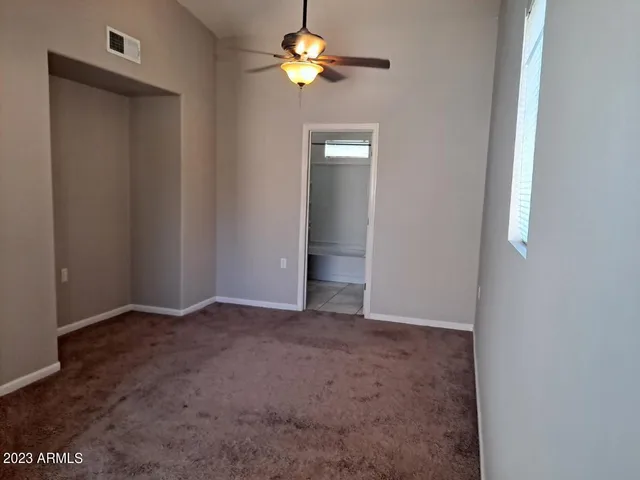 a view of a chandelier fan and closet in a room