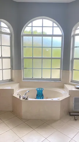 a bathroom with a bathtub and window