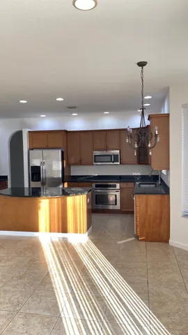 a kitchen with stainless steel appliances granite countertop a sink and a stove