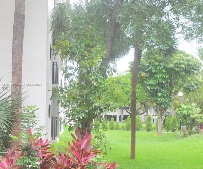 17011 North Bay Road, Unit 202 Sunny Isles Beach, FL 33160 - Photo 25 of 32 a backyard of a house with lots of green space and garden