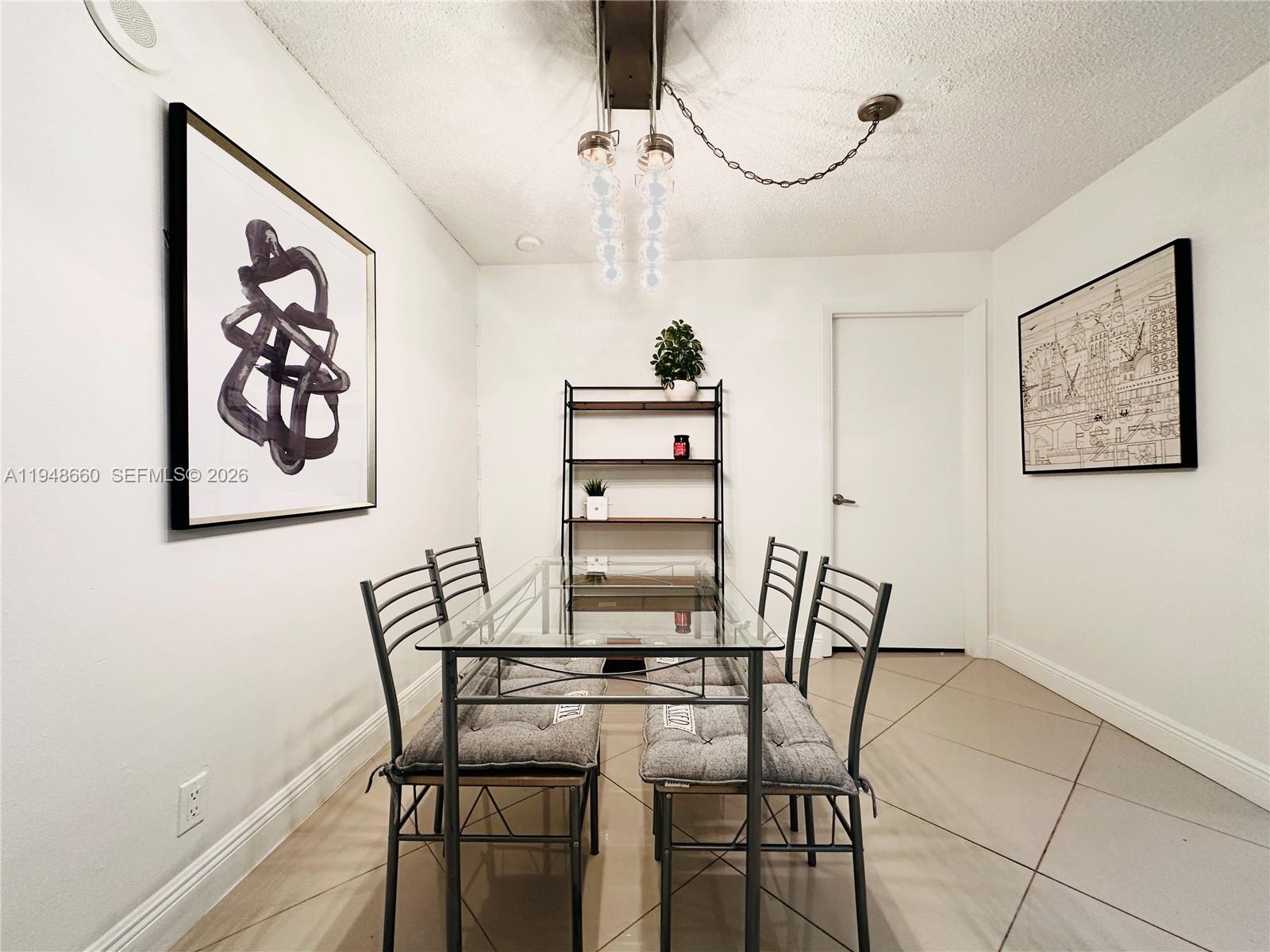 17011 North Bay Road, Unit 202 Sunny Isles Beach, FL 33160 - Photo 9 of 32 a view of a dining room with furniture