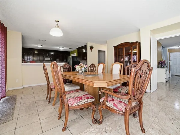 a view of a dining room with furniture and chandelier