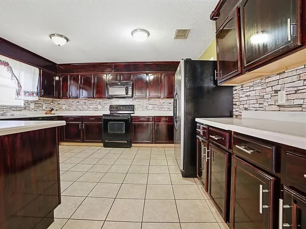 a kitchen with stainless steel appliances granite countertop a stove sink and cabinets