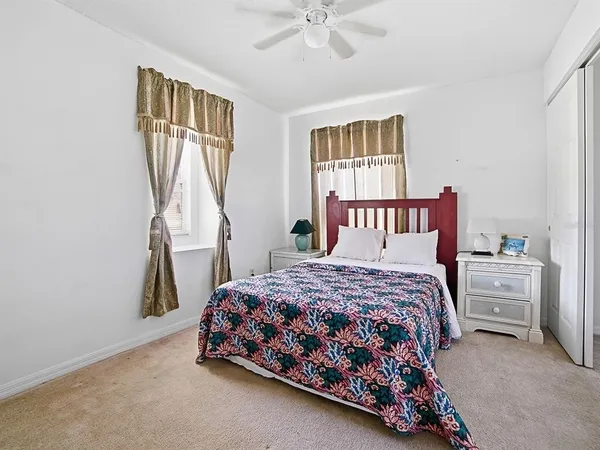a bedroom with a bed dresser and a window