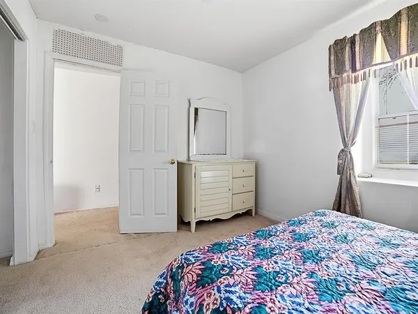 a bedroom with a large bed and a window