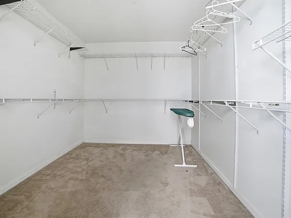 a spacious bedroom with two beds and painting on the wall