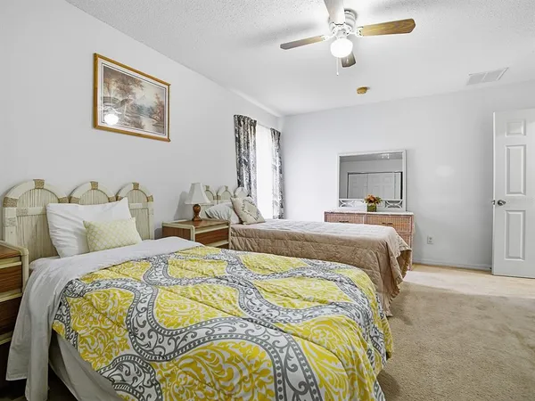 a dining room with furniture and a floor to ceiling window