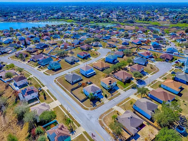 an aerial view of a houses with yard
