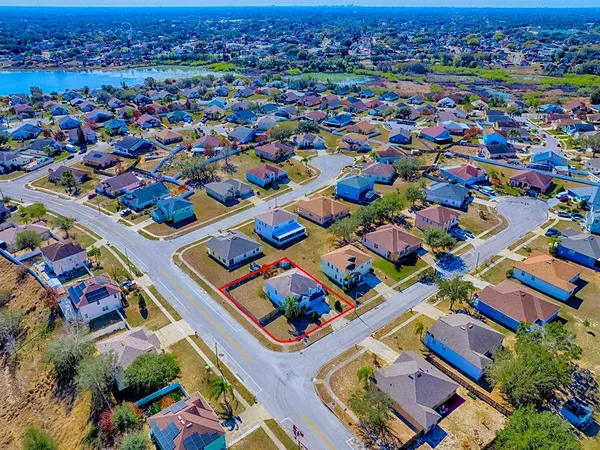 an aerial view of a houses with yard