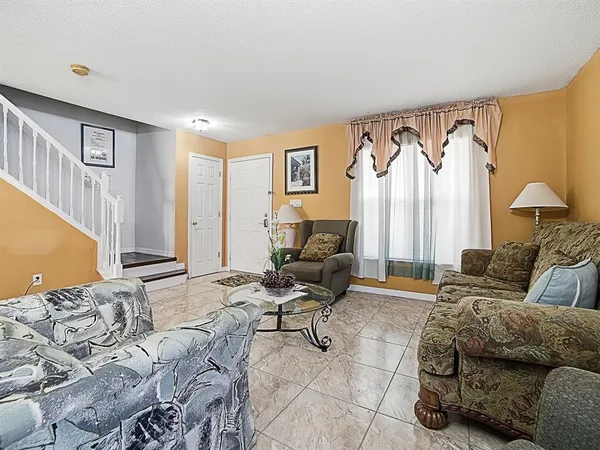 a living room with furniture and a chandelier