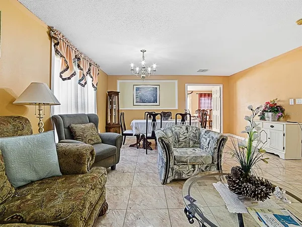 a view of a dining room with furniture and a chandelier