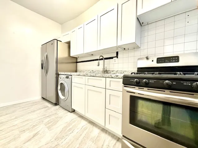 a kitchen with appliances cabinets and a sink