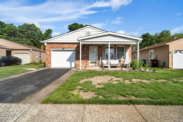 a front view of a house with yard patio and green space