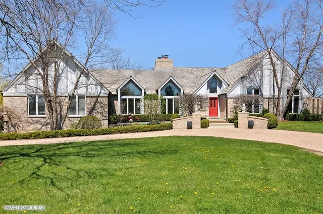 a view of a house with a yard and sitting area