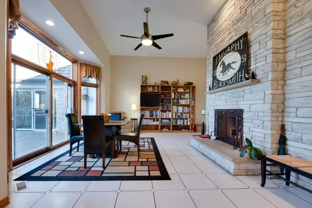 a dining room with furniture a potted plant and a rug