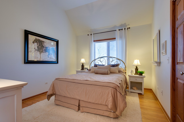 14080 West Old School Road Mettawa, IL 60048 - Photo 20 of 64 a bedroom with a bed and a painting on the wall