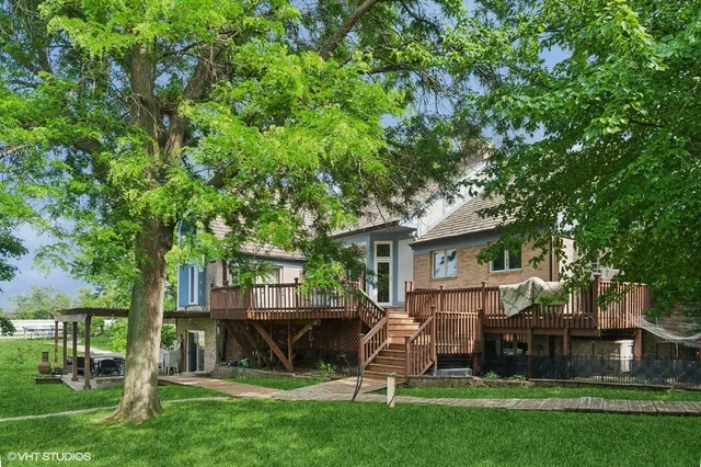 a backyard of a house with plants and tree
