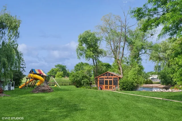 a view of a chair and tables in the backyard of the house
