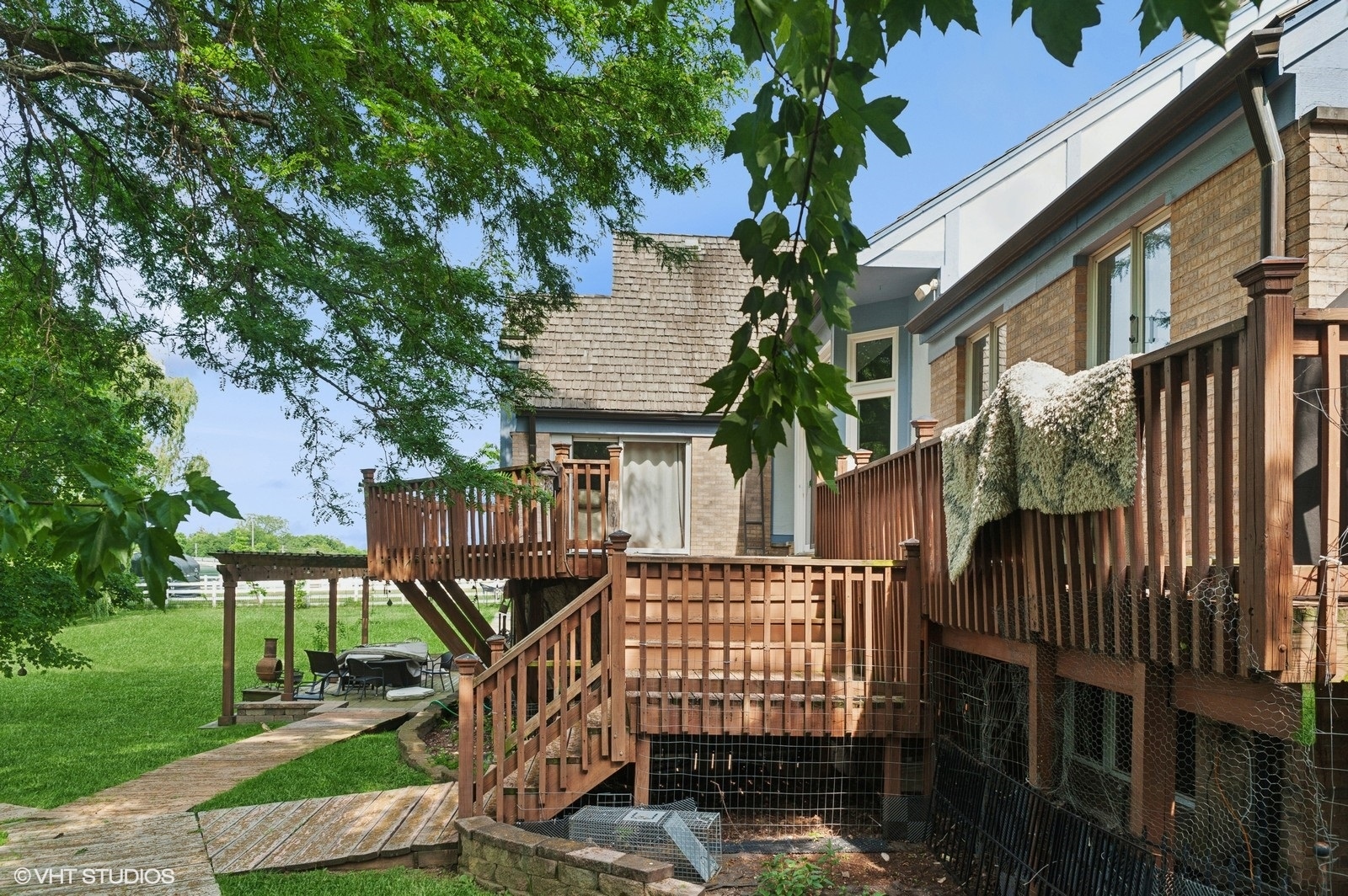 14080 West Old School Road Mettawa, IL 60048 - Photo 30 of 64 a view of a house with a small yard and wooden fence