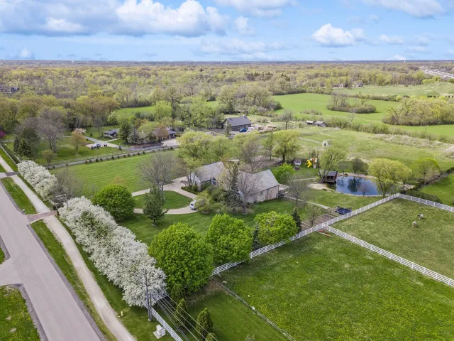 front view of house with a yard and potted plants