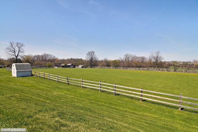 14080 West Old School Road Mettawa, IL 60048 - Photo 6 of 64 a view of a lake with a big yard