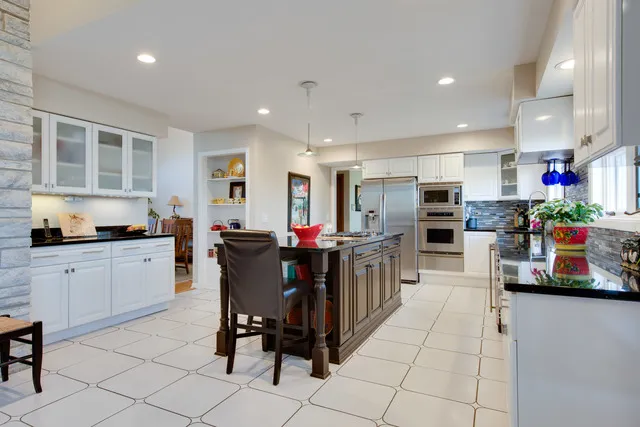 a living room with furniture a fireplace and a large window