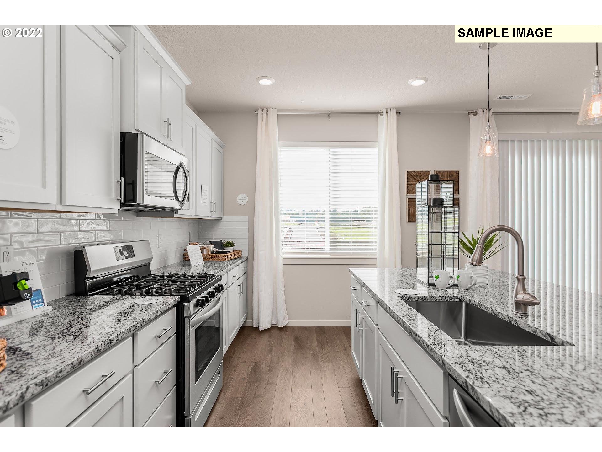 37528 Coho Street Sandy, OR 97055 - Photo 8 of 23 a kitchen with stainless steel appliances granite countertop a sink stove and cabinets