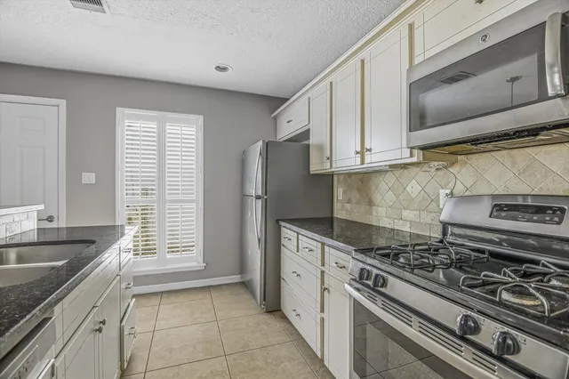 a kitchen with a stove and a sink