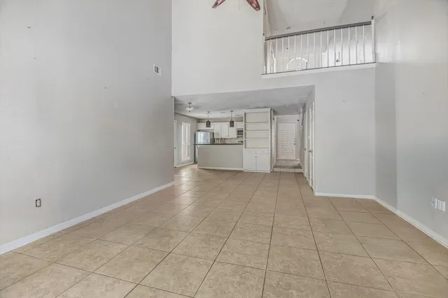 an empty room with a empty space and windows