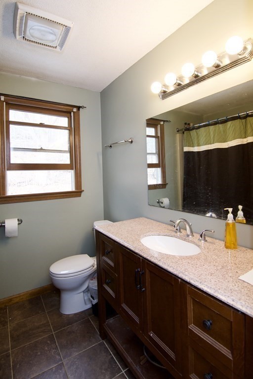 102 Stebbins Road Monson, MA 01057 - Photo 35 of 35 a bathroom with a granite countertop sink a mirror and a toilet