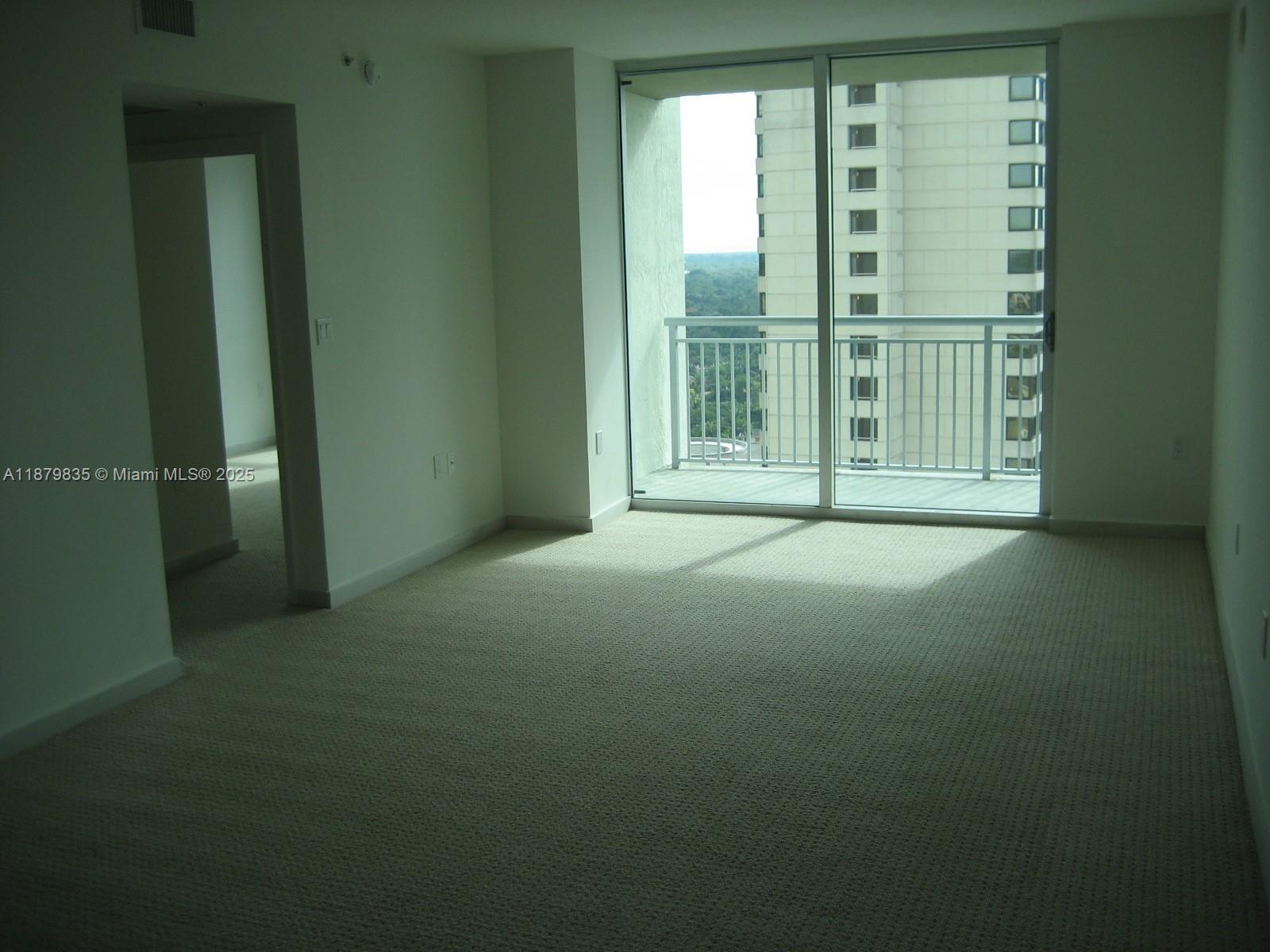 9066 Southwest 73rd Court, Unit 1802 Miami, FL 33156 - Photo 4 of 12 a view of empty room with floor to ceiling window