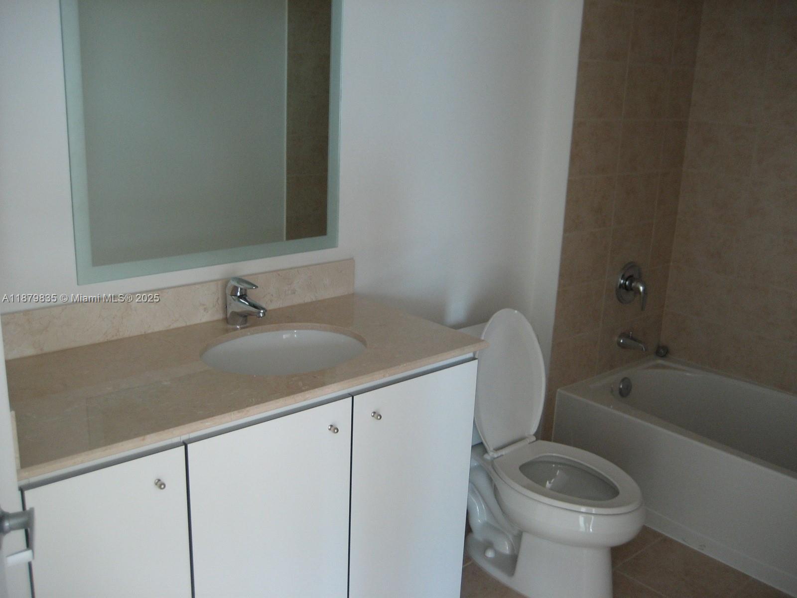 9066 Southwest 73rd Court, Unit 1802 Miami, FL 33156 - Photo 5 of 12 a bathroom with a sink toilet and bathtub