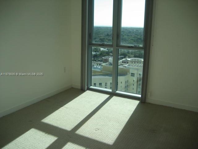9066 Southwest 73rd Court, Unit 1802 Miami, FL 33156 - Photo 6 of 12 a view of an empty room with windows