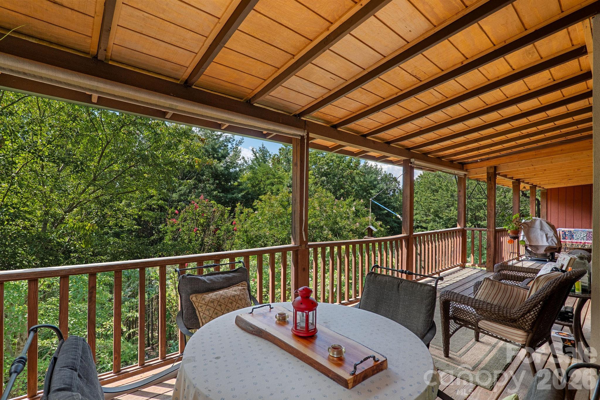 150 Avondale Ridge Road Asheville, NC 28803 - Photo 17 of 45 a view of a chair and tables in the balcony