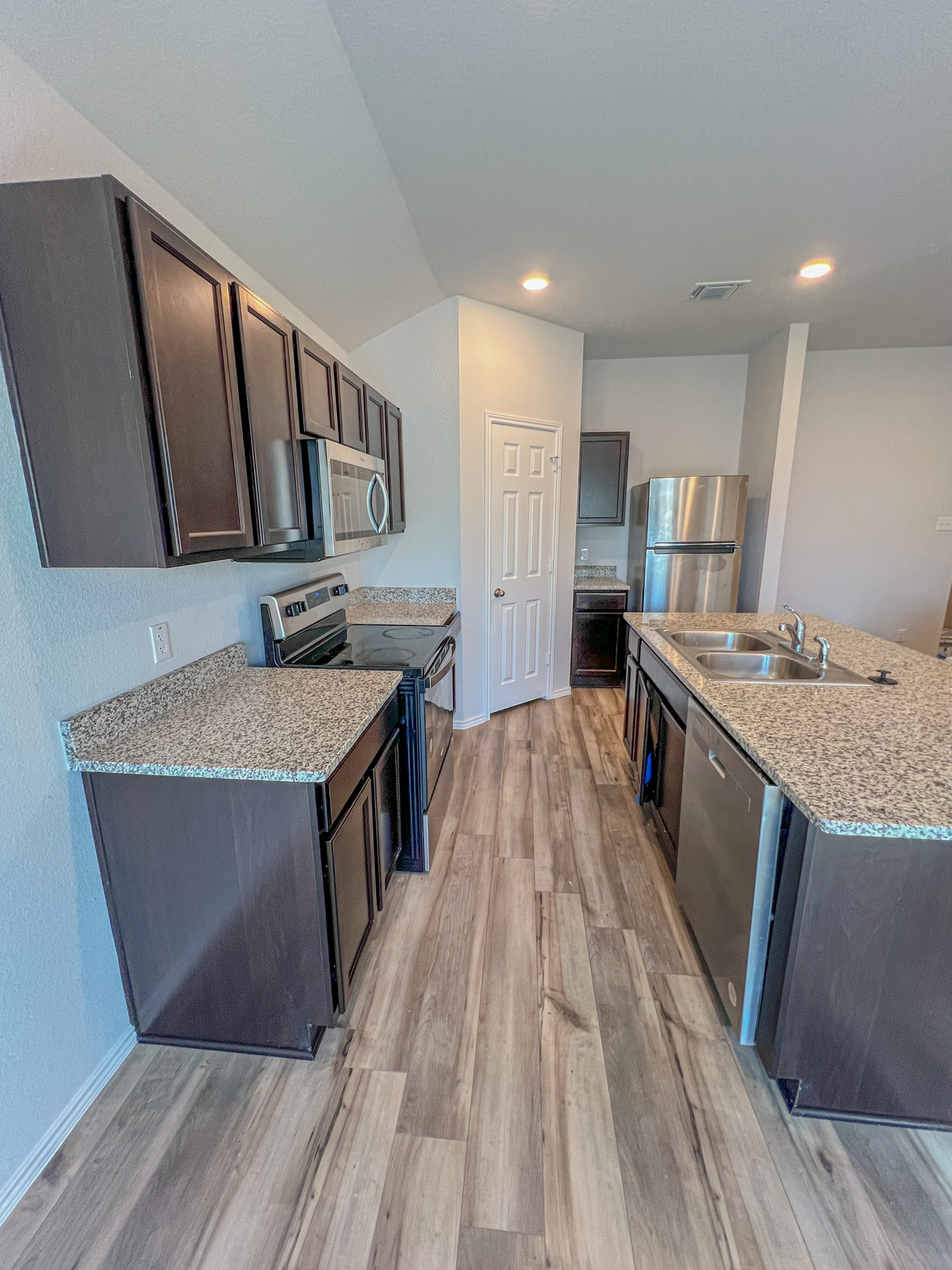 100 Taggart Trail Jarrell, TX 76537 - Photo 11 of 18 a kitchen with a sink a counter top space and cabinets