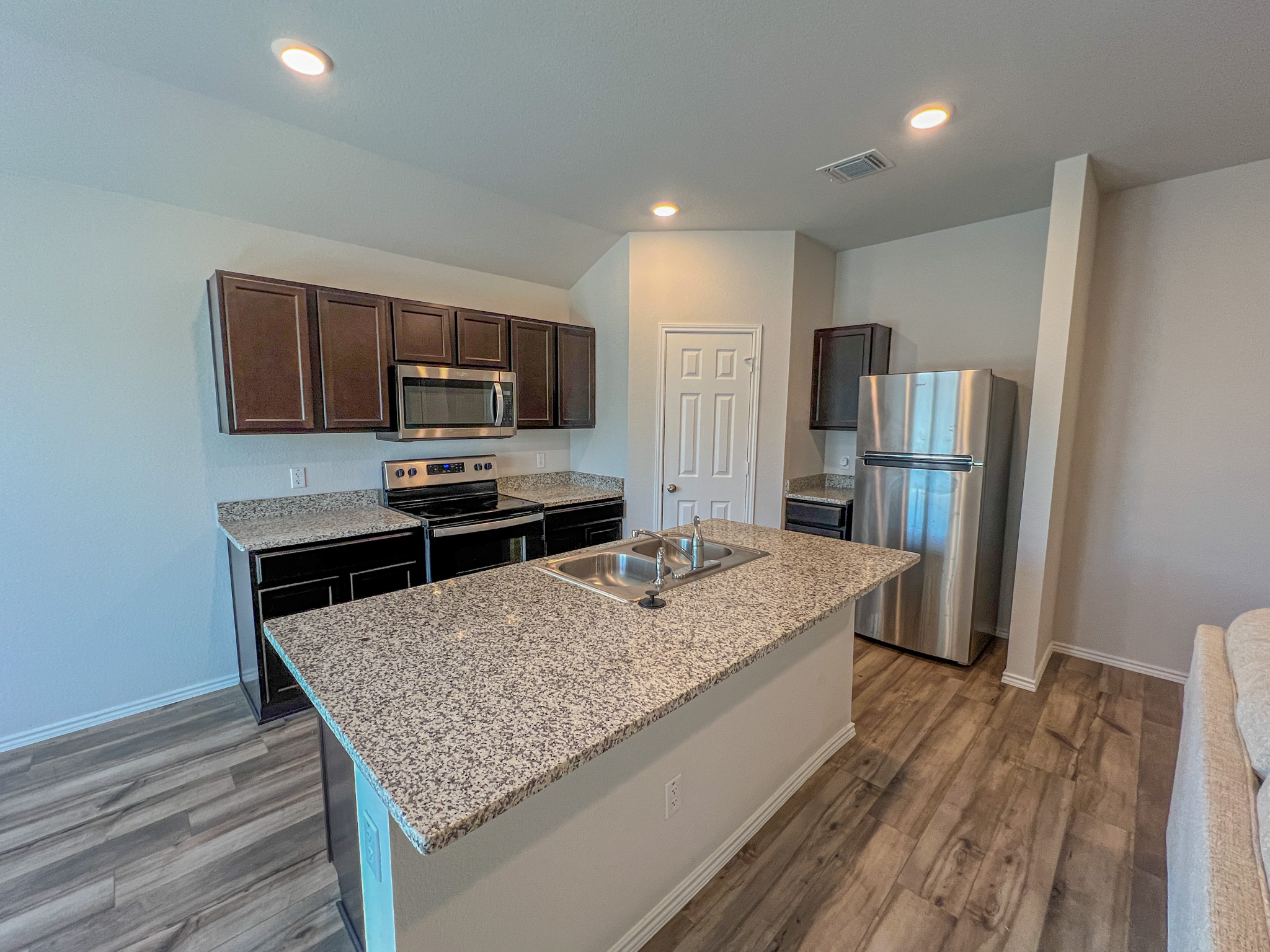 100 Taggart Trail Jarrell, TX 76537 - Photo 10 of 18 a kitchen with stainless steel appliances granite countertop a refrigerator microwave stove and oven