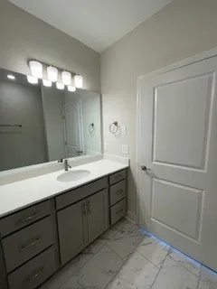 a bathroom with a glass shower door