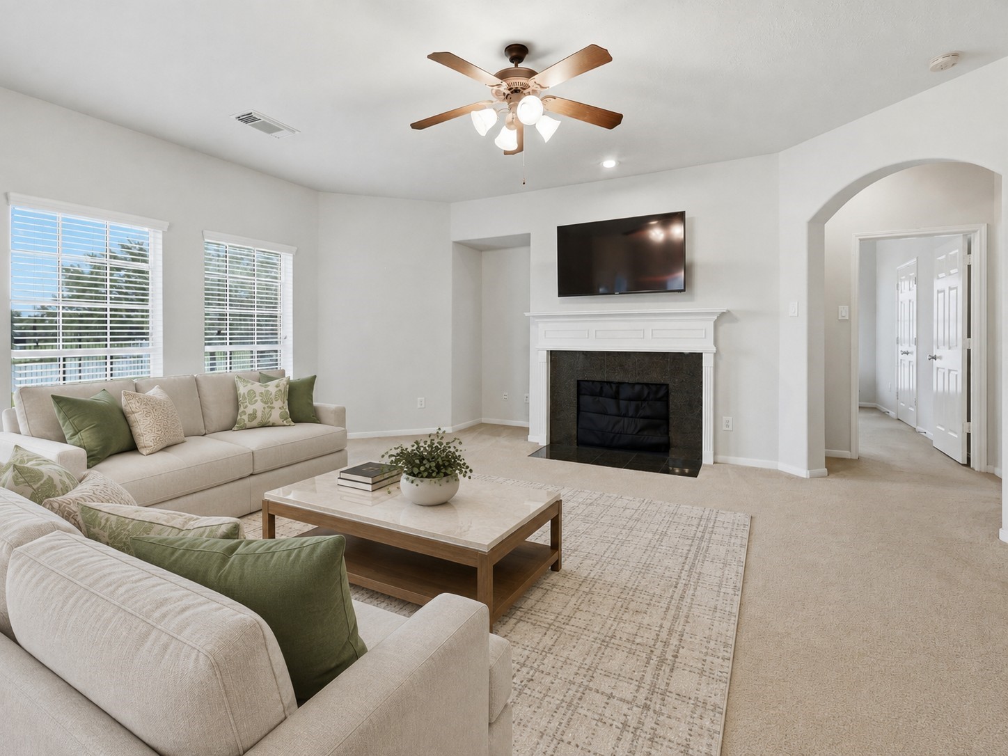 13806 Cove Landing Lane Rosharon, TX 77583 - Photo 19 of 44 The family room is anchored by a classic fireplace and enhanced by large windows, generous proportions, and an arched hallway entrance.**Virtually staged