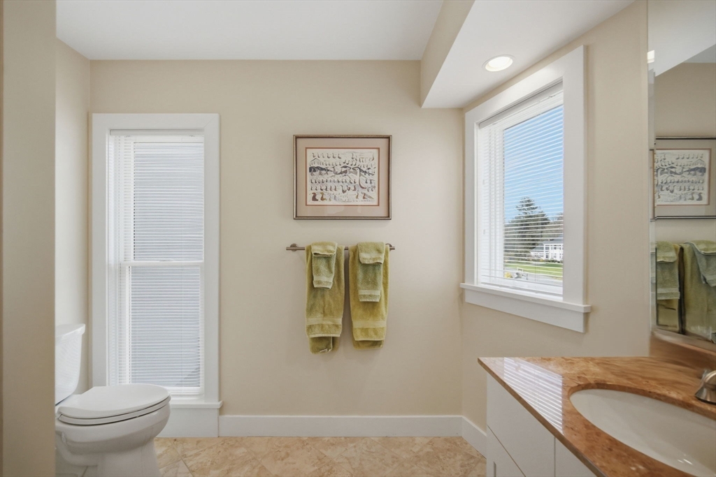 24 Prynne Ridge Road Longmeadow, MA 01106 - Photo 37 of 42 a bathroom with a granite countertop sink toilet and painting