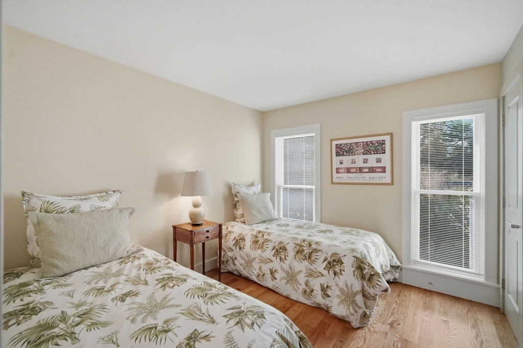 24 Prynne Ridge Road Longmeadow, MA 01106 - Photo 38 of 42 a bedroom with a large bed and a wooden floor