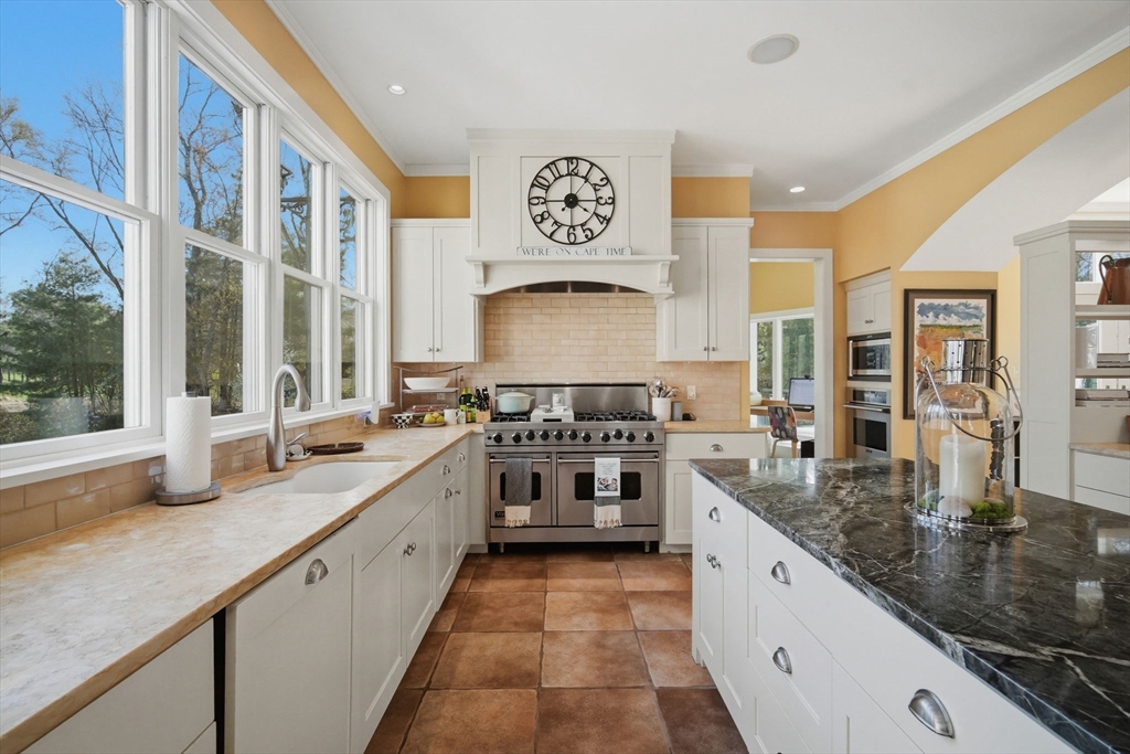 24 Prynne Ridge Road Longmeadow, MA 01106 - Photo 10 of 42 a large white kitchen with stainless steel appliances granite countertop a stove and a sink