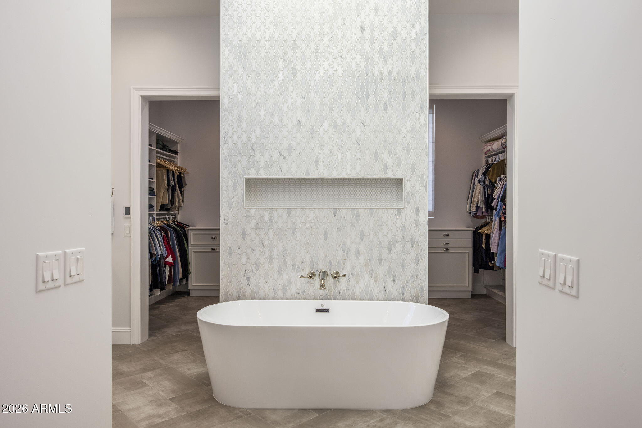 2677 East Maplewood Street Gilbert, AZ 85297 - Photo 8 of 20 a white bath tub sitting in a en suite bathroom