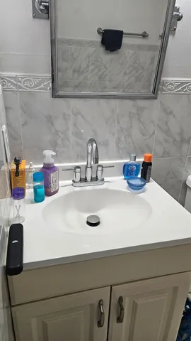 a kitchen with a sink a stove and cabinets