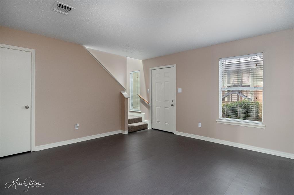 5705 East Texas Street, Unit 80 Bossier City, LA 71111 - Photo 3 of 15 an empty room with wooden floor and windows