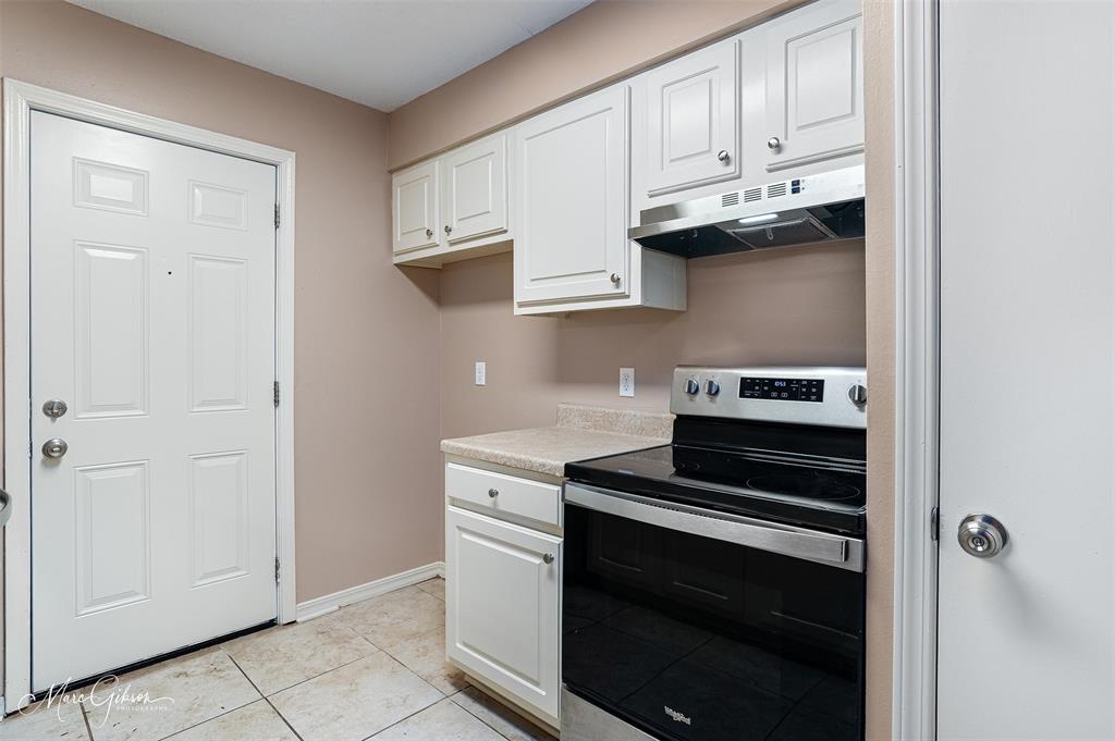 5705 East Texas Street, Unit 80 Bossier City, LA 71111 - Photo 7 of 15 a kitchen with stainless steel appliances granite countertop white cabinets and a stove