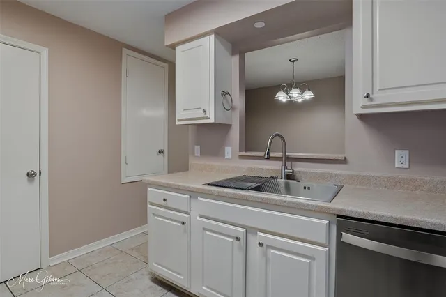 a kitchen with cabinets and white appliances