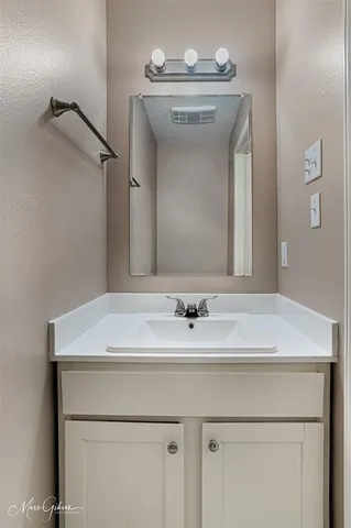 a bathroom with a sink a vanity and a mirror