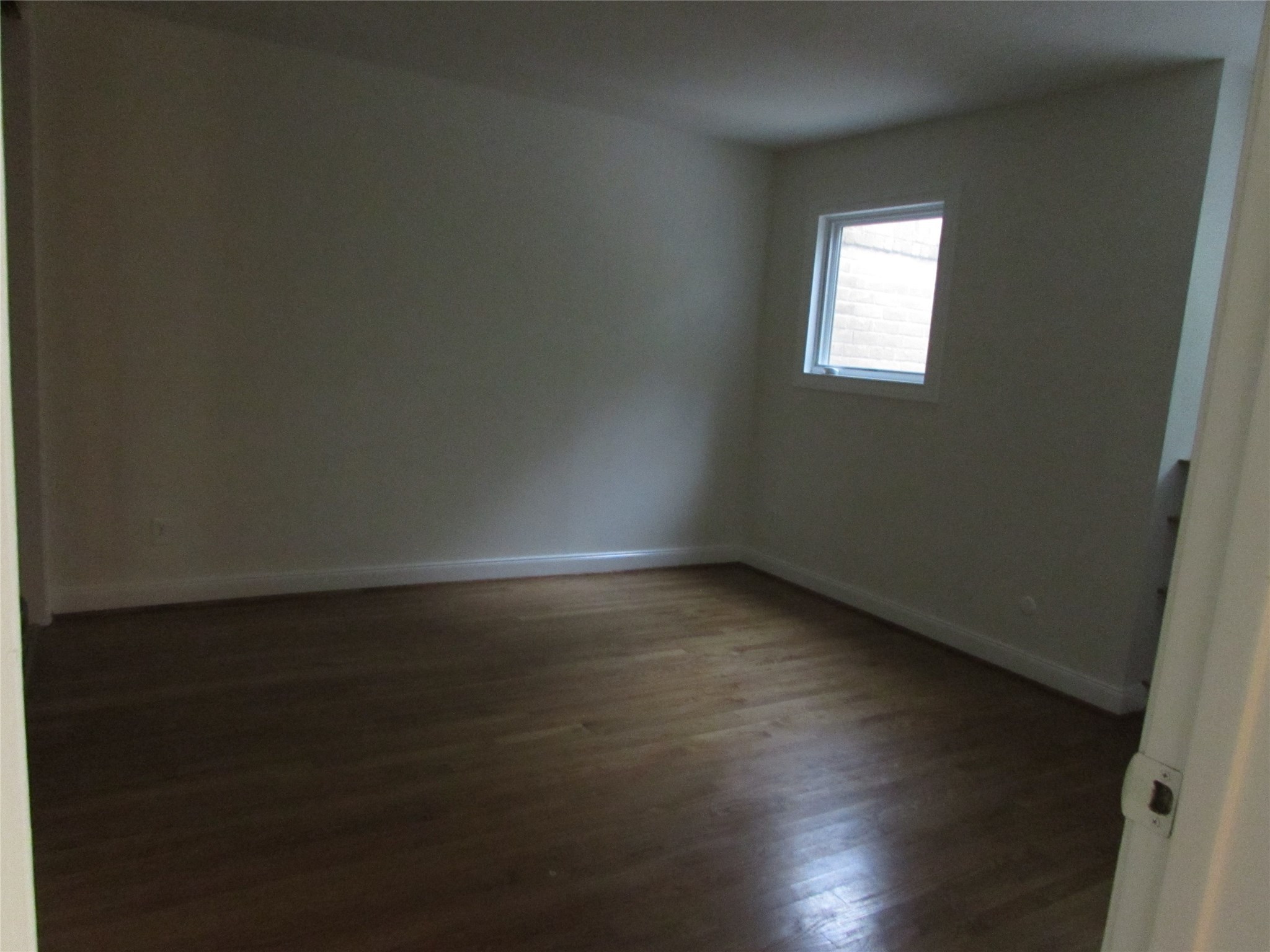 201 Vanderpool Lane, Unit 19 Houston, TX 77024 - Photo 22 of 23 a view of wooden floor and windows in a room
